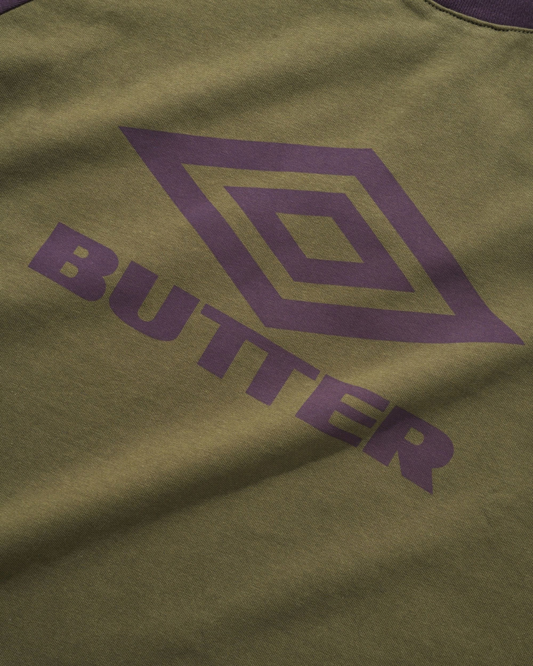 BUTTER GOODS | UMBRO Diamond Logo Raglan Tee - Army/Eggplant